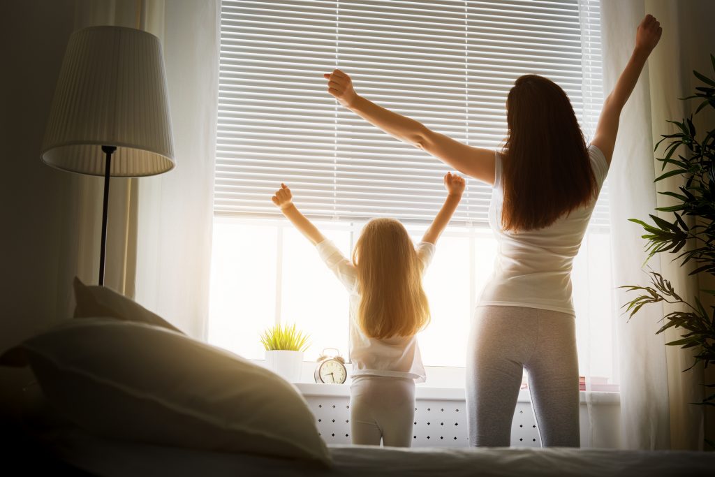 Mother and daughter stretching before the day