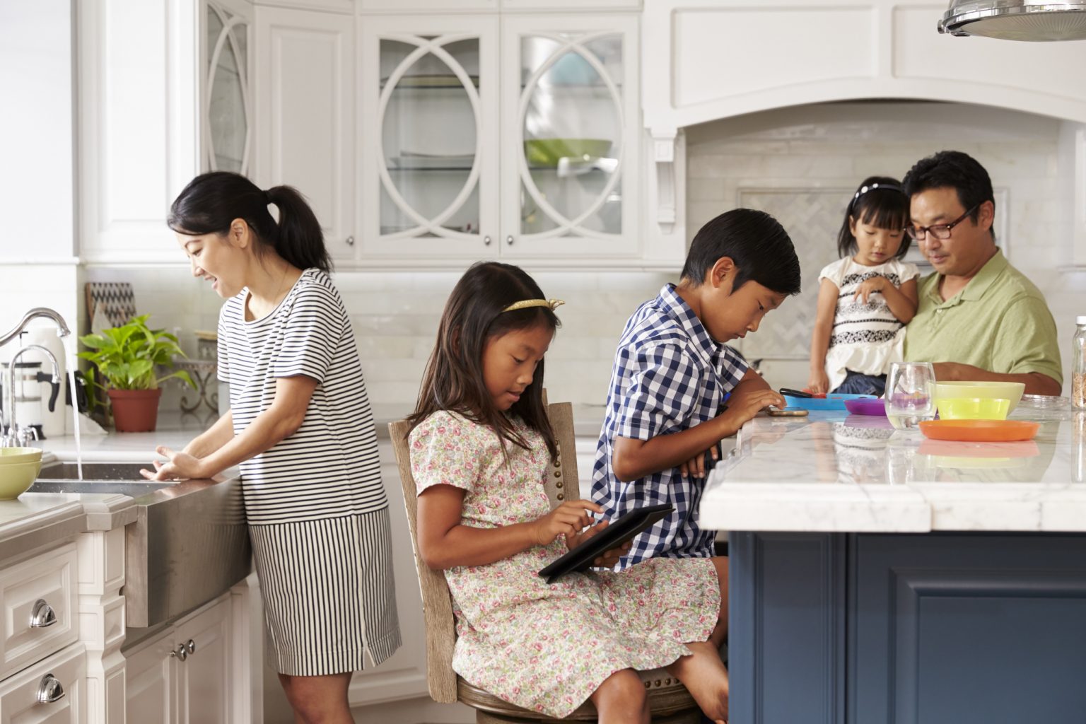 family-in-kitchen-doing-chores-and-using-digital-devices-sensory